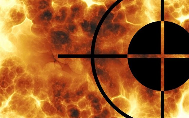 crosshairs in foreground of flames and explosion